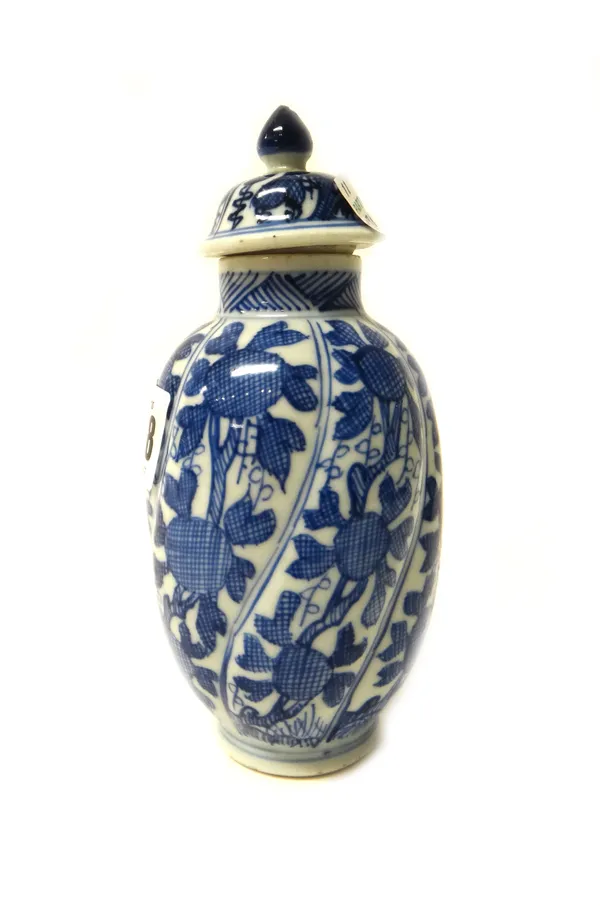 A small Chinese blue and white spiral moulded ovoid vase and a cover, Kangxi, painted with panels of fruiting branches,(a.f),  15cm. high.