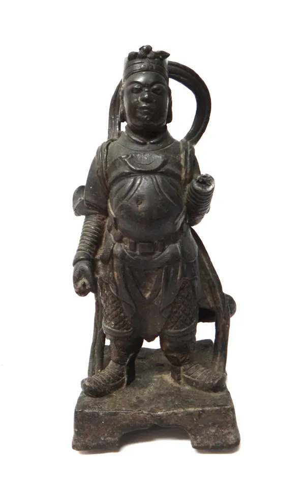 A Chinese bronze figure of an official or soldier, probably Ming dynasty, 17th century, standing on a cut square base, (a.f), 31cm. high