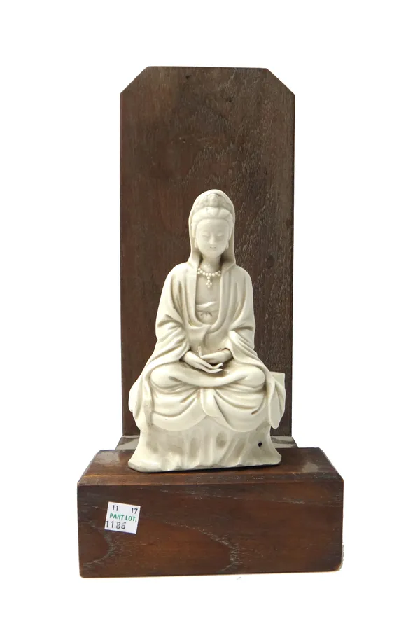 A Chinese blanc de chine figure of Guanyin, seated in meditation on a rockwork base with hands in dhyanamudra, (a.f), 16.5cm.high, wood stand.