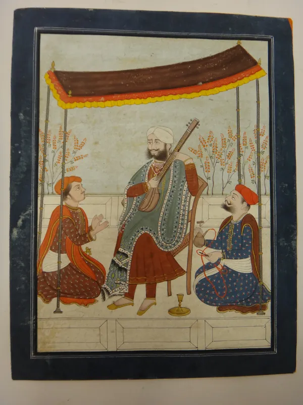 Punjab school, circa 1830, a royal playing a sitar  in a tent with two attendants, opaque pigments on paper, Persian blue border, image 18cm. by 13cm.