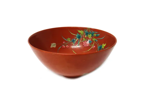 A Chinese iron-red ground bowl, six character Yongzheng mark but later, painted in famille-rose enamels with three geese standing on rocks amongst flo