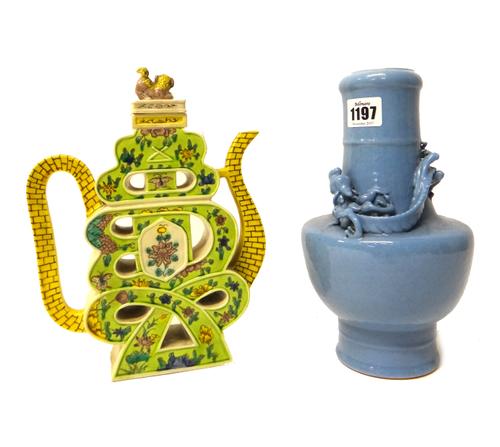 A Chinese blue glazed vase, Qianlong seal mark but later, with tapered cylindrical neck, the shoulder applied in relief with a sinuous dragon, 25cm. h