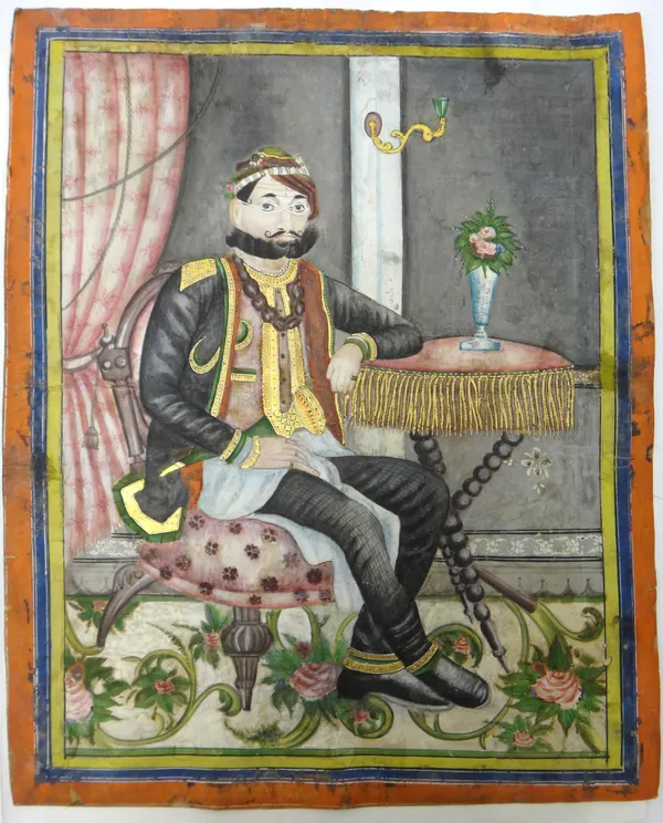 Jaipur School, 1860's, portrait of Maharajah Sawai Ram Singh II seated at a table, opaque pigments on paper, inside yellow, blue and red borders, 44cm