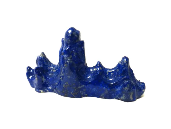 A small Chinese lapis  lazuli brush rest, in the form of a mountain range, 10.5cm. wide.