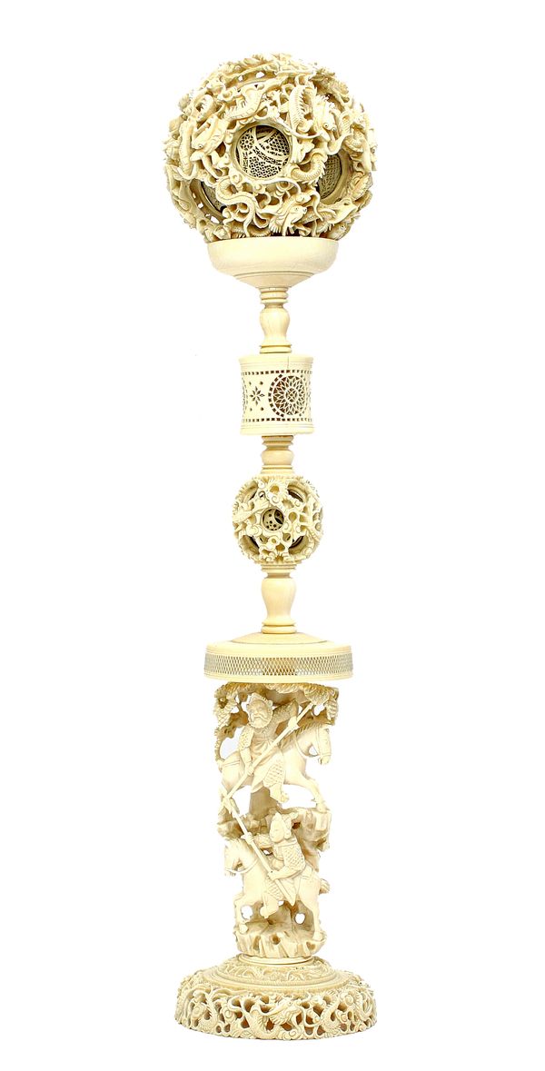 A Chinese ivory puzzle ball and stand, late 19th/20th century, the ball and pierced on the exterior with dragons amongst cloud scrolls, enclosing appr