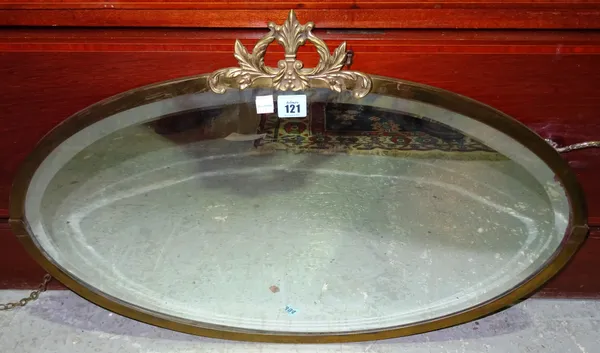 A 20th century brass oval mirror, 72cm wide x 42cm high. F10