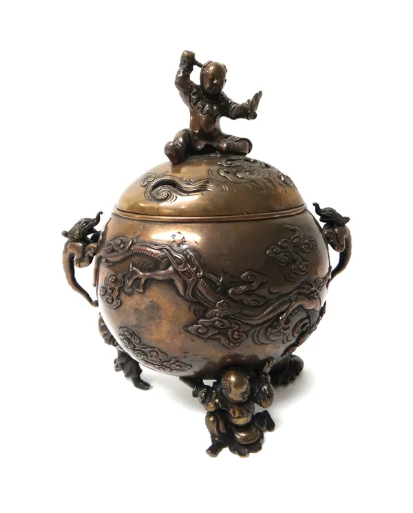 A Japanese bronze two-handled  koro and cover, Meiji period, of oval form, each side cast in relief with a dragon amongst cloud scrolls, supported by