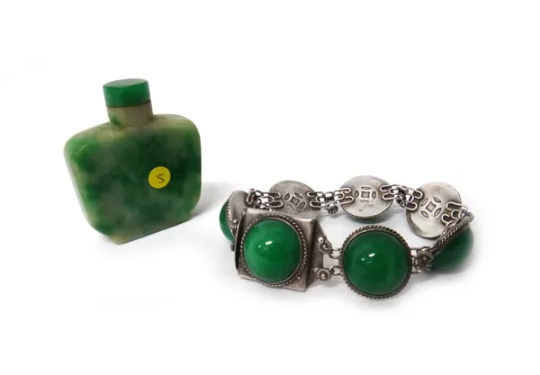 A Chinese mottled green jadeite snuff bottle, 5cm. high; and a Chinese jadeite and silver bracelet, stamped marks.