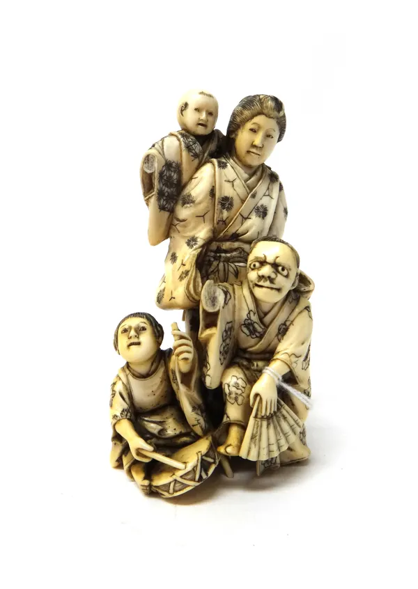 Three Japanese ivory okimono, Meiji period, comprising; a mother and three children, 11cm. high; a fisherman and child 11cm. high; and a figure of a t