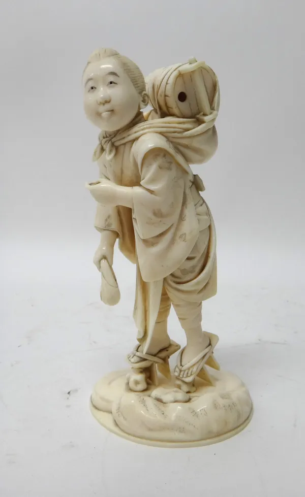 A Japanese ivory okimono, Meiji period, carved as a girl carrying a water bucket across her back and holding an umbrella (a.f), signed on red lacquer