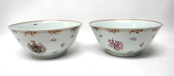 A pair of 'famille-rose' armorial punchbowls, late 19th/20th century, painted with the arms of Boume amongst flower sprays, 40.5cm diameter (2).