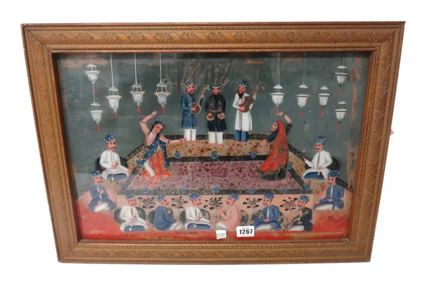 An Indian reverse glass painting, Gujarat, early/mid 19th century, painted with dancers and musicians entertaining gentlemen at a feast, 33cm by 48.5c