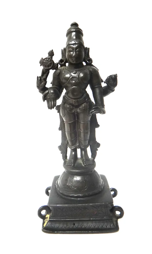An Indian bronze figure of Vishnu, 18th/19th century, the four-armed deity standing on a dome and square base, his primary hands in varada mudra, one