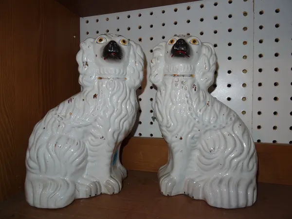 A pair of Staffordshire pottery seated spaniels, 19th century, 25.5cm. high. (2) CAB