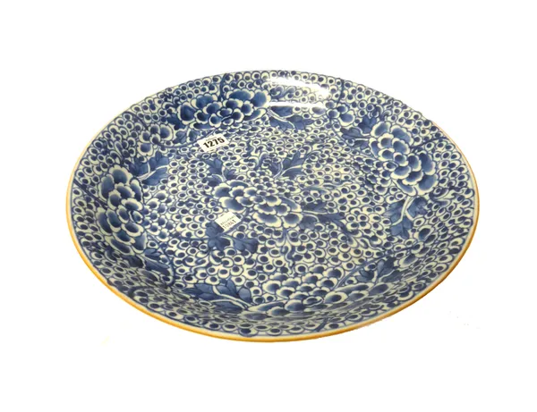 A Chinese blue and white dish, Kangxi, painted with flowering peony, 34.5cm. diameter.