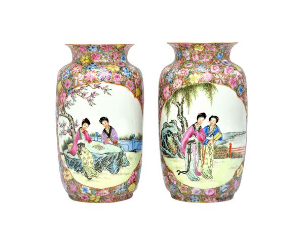 A pair of Chinese famille-rose `eggshell' vases, 20th century, of cylindrical form with everted rim, each painted with two panels enclosing two young