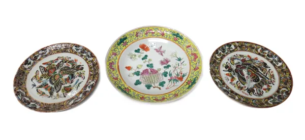 A pair of Chinese porcelain plates, circa 1900, each enamelled with a profusion of butterflies, 21cm. diameter; also a famille-rose plate painted with