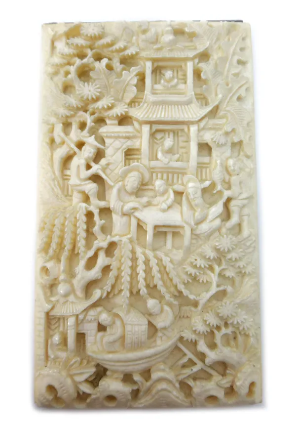 A Canton ivory rectangular panel, late 19th century, carved with figures amongst pavilions and trees and in a boat, set in a pierced wood frame enclos