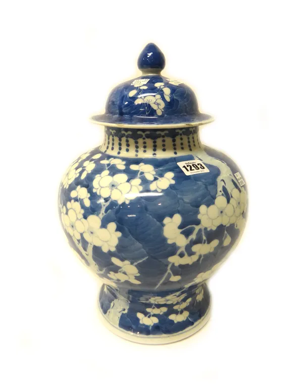 A Chinese blue and white baluster vase and cover, late 19th century, painted with prunus on a `cracked ice' ground, six character Kangxi mark, 39cm.hi