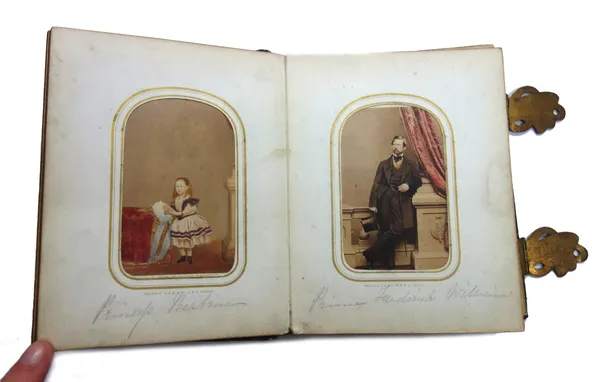 PHOTOGRAPHS - a leatherbound album of carte de visite, some coloured- in, approx. 30; includes some of Queen Victoria's children, Prince of Wales, the
