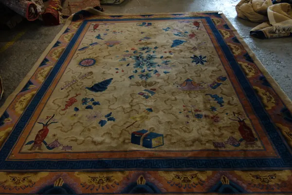 A Chinese carpet, with brown field and blue borders 322cm x 247cm. E4