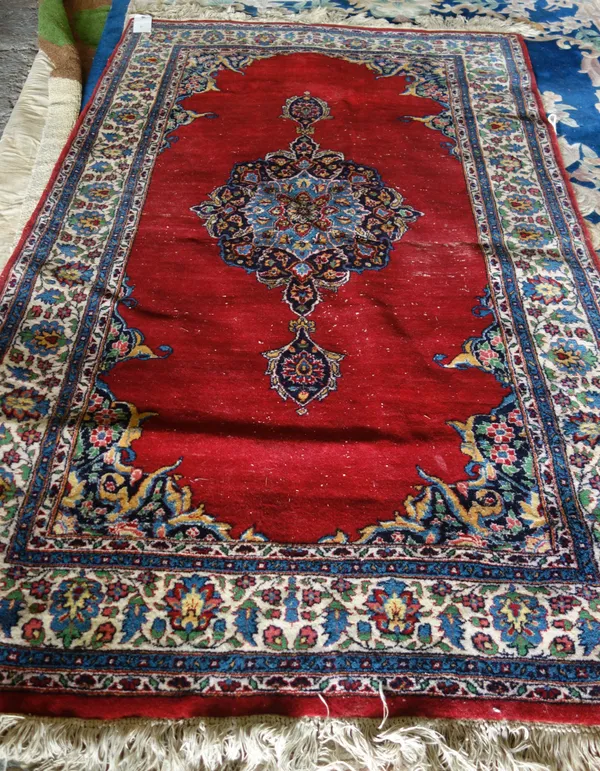 An Indian rug of Persian design, with central medallion on a red ground.  220cm x 139cm. F3