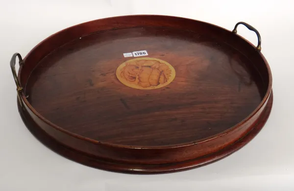 A George III galleried circular mahogany serving tray, with conch shell inlay and brass loop handles, 46cm diameter x 8cm high.
