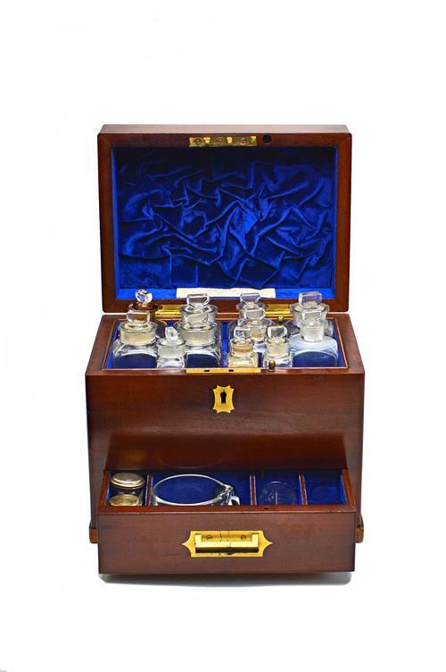 A mid-19th century mahogany apothecary box, the lift top and lower drawer enclosing a fitted interior, 23cm wide x 20cm high x 17cm deep.  Illustrated