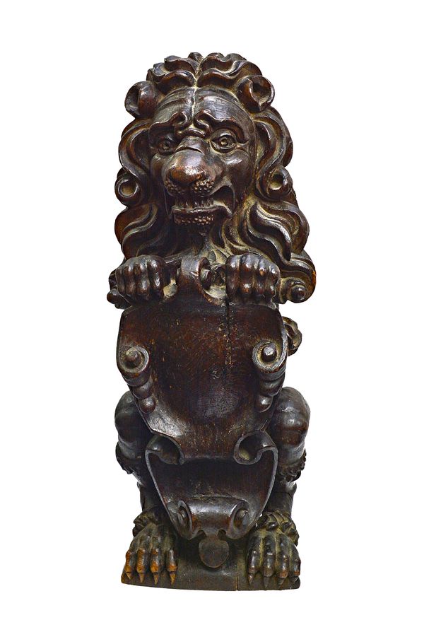 An 18th century carved oak figure of a sejeant lion, 24cm wide x 61cm high.  Illustrated