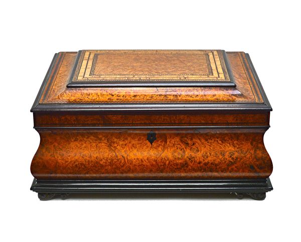 A 19th century tulipwood banded walnut sewing box, of bloated sarcophagus form, with fitted interior, 33cm wide x 18cm high x 25cm deep.  Illustrated