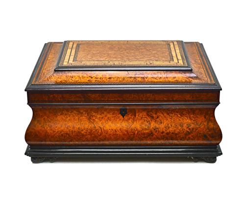 A 19th century tulipwood banded walnut sewing box, of bloated sarcophagus form, with fitted interior, 33cm wide x 18cm high x 25cm deep.  Illustrated