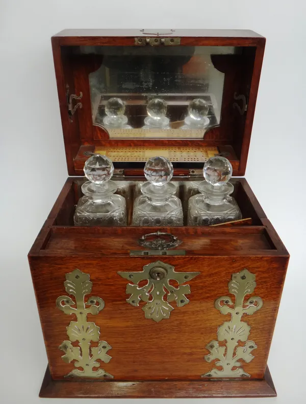 A Victorian brass mounted oak decanter/games compendium box with lift top and fall front, enclosing a fitted interior, 36cm wide x 37cm high x 29cm de