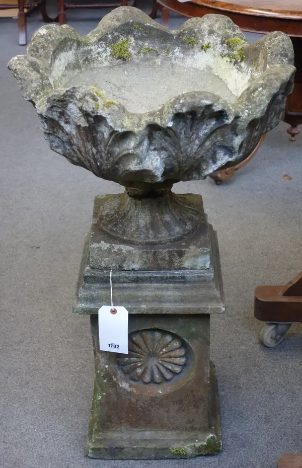 A reconstituted stone jardiniere with leaf moulded body and fluted socle on stepped square base, 54cm wide x 95cm high.