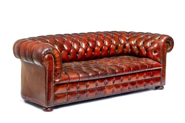 A brown leather upholstered Chesterfield sofa, with brass studded decoration, 220cm wide x 75cm high x 90cm deep.  Illustrated