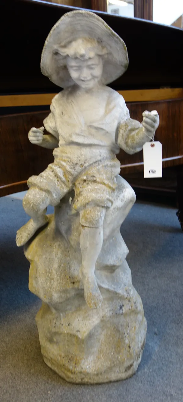 After Goldscheider, a reconstituted stone statue of a young fisher boy, wearing a wide brim hat, sat on rocks, 45cm wide x 134cm high.