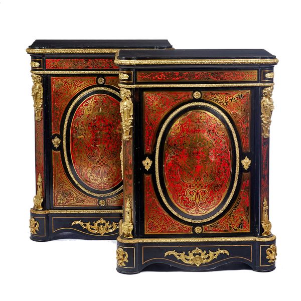 A pair of Napoleon III gilt metal mounted premier and contra partie Boulle work side cabinets, each with raised oval panel door flanked by canted corn