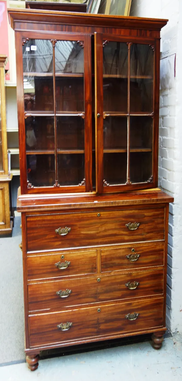 A late George III mahogany secretaire bookcase, the pair of glazed doors over fitted drawer and two short and two long drawers, on turned feet, 100cm