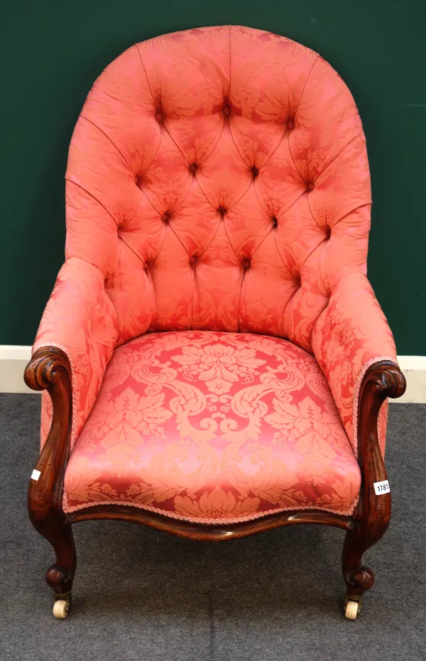 A mid-Victorian oak framed tub back easy armchair, with serpentine seat on scroll supports, 68cm wide x 98cm high x 72cm deep.