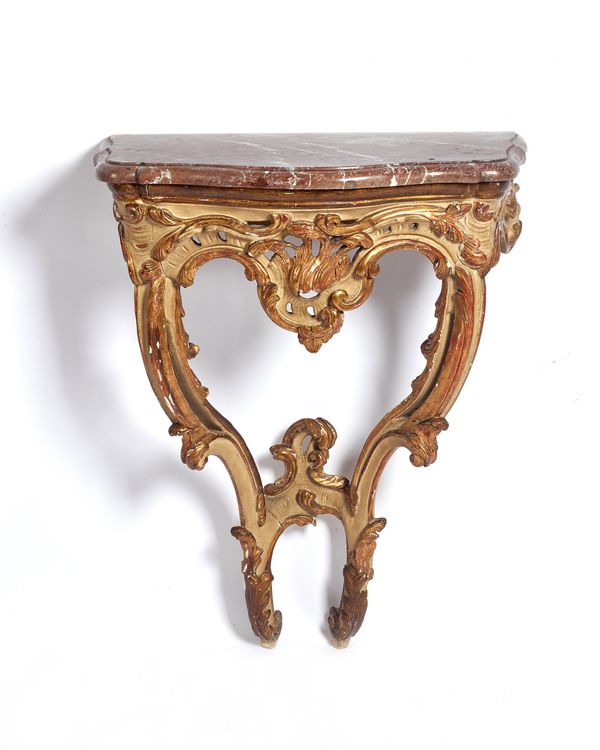 A small 18th century pier table, the serpentine marble top on a parcel gilt cream painted base with opposing 'C' scroll supports, 52cm wide x 107cm hi