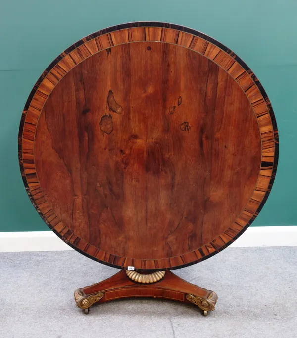 A Regency ormolu mounted rosewood centre table, the coromandel banded circular snap top on a turned column and trefoil platform, 120cm diameter x 73cm