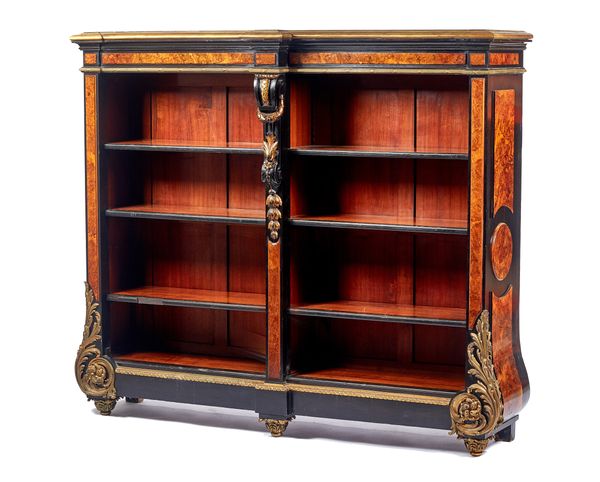 A 19th century French style ormolu mounted figured walnut ebony and ebonised floor standing open bookcase in the Louis XIV style, with bombe sides and