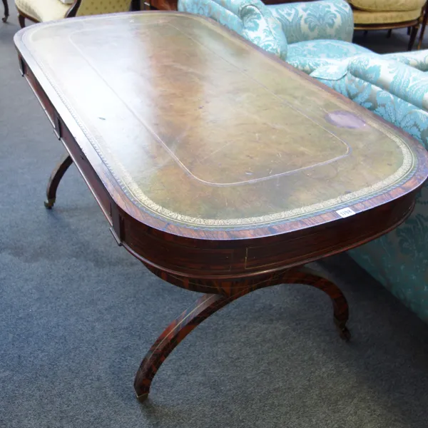 A Victorian rosewood centre writing table, the leather inset rounded rectangular top with two pairs of opposing frieze drawers, raised on a faux rosew