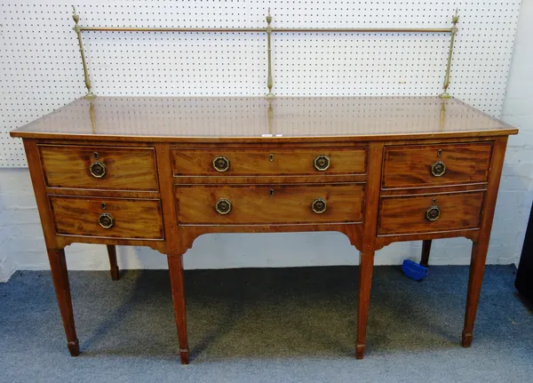 An early 19th century Kingwood banded mahogany bowfront sideboard, the brass galleried back over five frieze drawers on tapering square supports, 168c