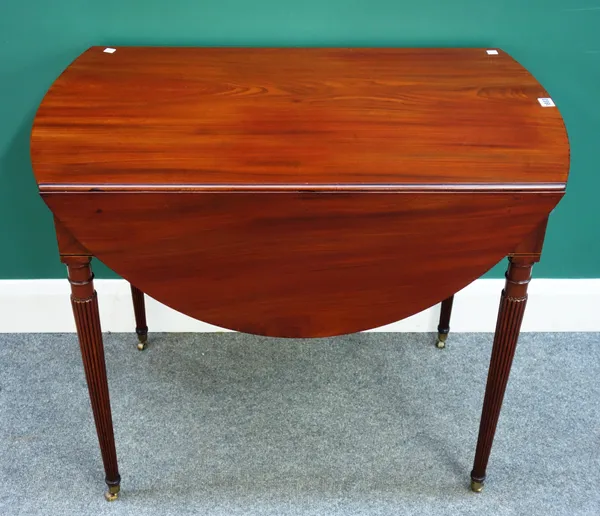 A George III mahogany drop flap Pembroke table, the oval top above single frieze drawer and dummy verso, on tapering reeded supports, 52cm wide, 110cm