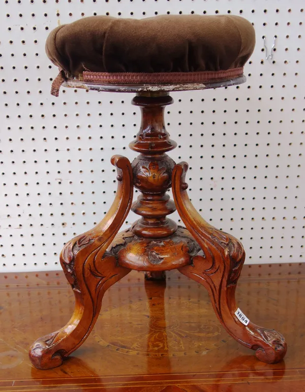 A Victorian stained beech piano stool, with circular height adjustable top on a carved tripod base, the top 34cm diameter.