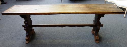 A 17th century and later Italian walnut console table, the single plank rectangular top on a pair of shaped trestle end supports, united by stretcher,