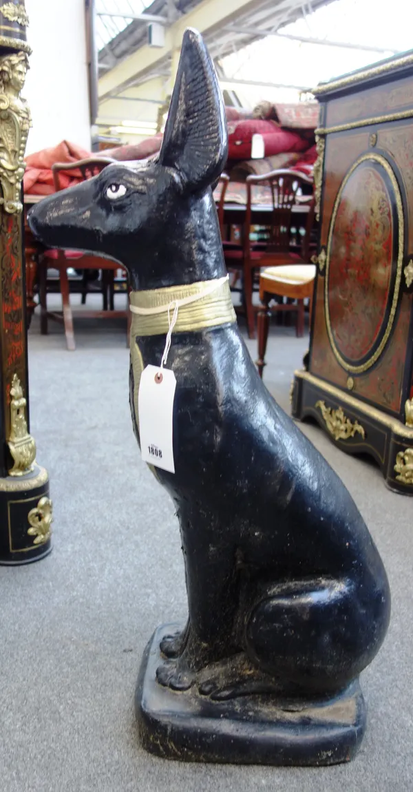 A pair of black and gold painted reconstituted stone figures of Egyptian style dogs, each in seated pose, 186cm high, (2).