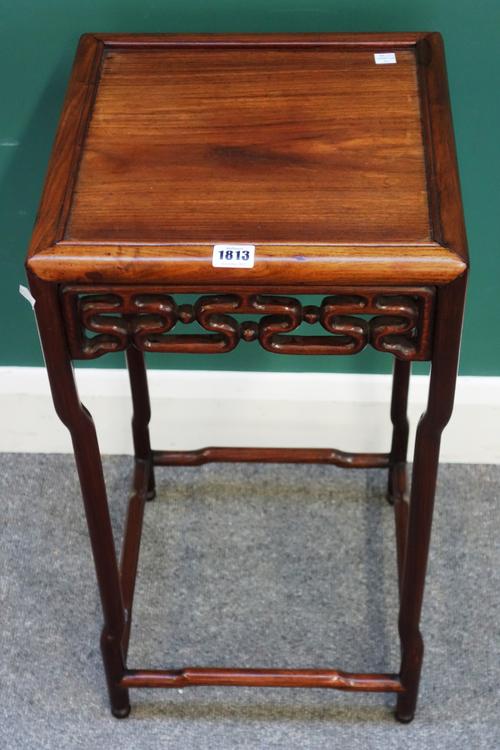 An early 20th century Chinese hongmu urn stand, with pierced frieze, on inverted turned supports united by perimeter stretcher, 35cm wide x 68cm high.