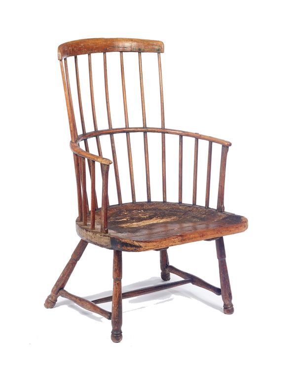 A George III elm seated comb back Windsor chair, on turned supports, retaining old traces of paint, 58cm wide x 97cm high x 55cm deep.  Illustrated