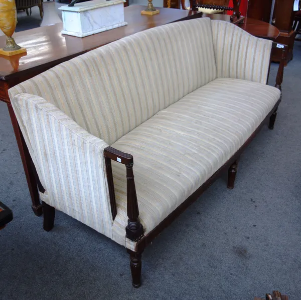 A Regency mahogany hump back sofa, with bow seat and reeded supports, 186cm wide x 86cm high x 80cm deep.
